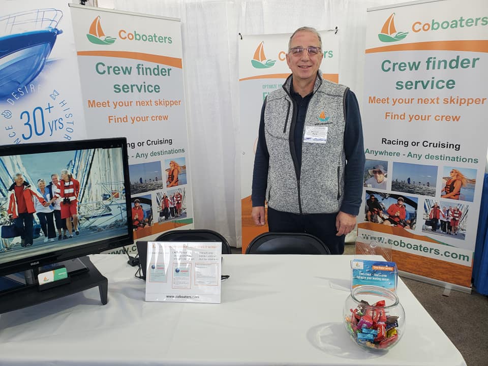 Phil, the founder of Coboaters at the Annapolis Sailboat Show in 2022. Background with Coboaters logo