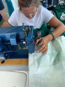 Kim is sewing the sail