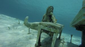 Sunken piano with a sculpture woman sitting behind