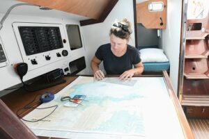 Female sailor on board at navigation table